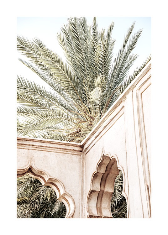  - Fotografie eines beigen Gebäudes mit geschwungenen Bögen vor einer Palme