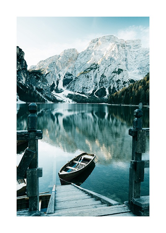  – Fotografie von verschneiten Bergen im Hintergrund eines Sees mit einem Boot und einer Holztreppe im Vordergrund