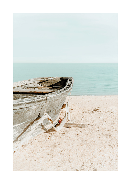  – Fotografie, die ein altes Boot im Sand an einem Strand zeigt, im Hintergrund Himmel und Meer
