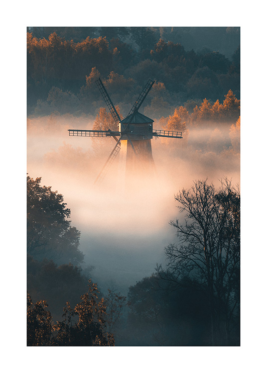  – Fotografie eines nebelverhangenen Waldes und einer Windmühle im Nebel. Sonnenlicht fällt auf den Wald