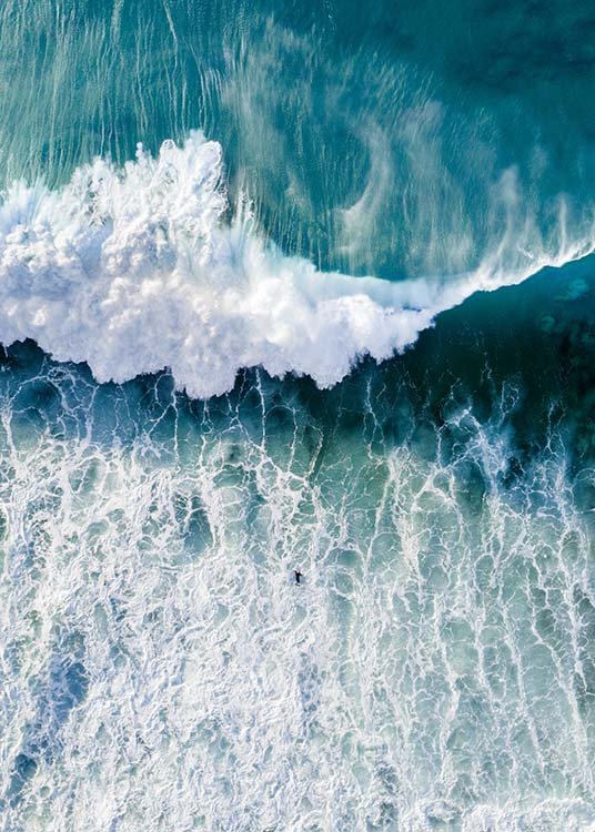  – Fotografie eines Meeres von oben mit großen Wellen, die auf einen Surfer zukommen